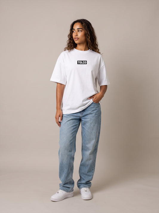 on-model: TOLCO TAG Pure Cotton T in White, worn with light-wash jeans