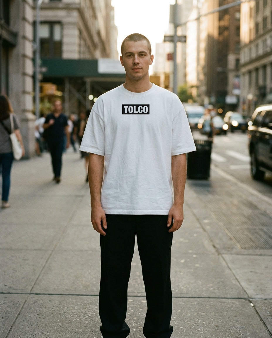 TOLCO on-model: TOLCO. - TAG - Pure Cotton T - White, front view, worn on the street